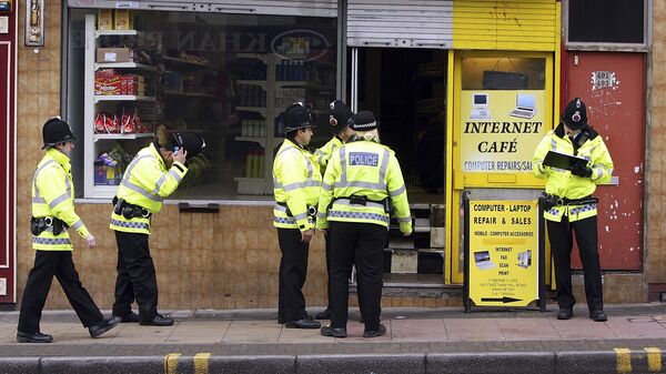 Police officers gather outside a property in the Cheetham Hill area of Manchester, England, Thursday, April 9, 2009 - Sputnik International