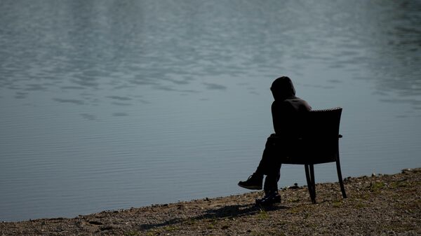 A migrant rests in a shelter at lake Schwarzlsee in Unterpremstaettten, about 200 kms (124 miles) south of Vienna, Austria, Tuesday, Sept. 22, 2015 - Sputnik International