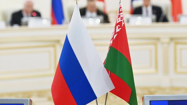 Russian and Belarusian national flags are pictured during a meeting of the High-Level Group of the Council of Ministers of the Union State of Russia and Belarus in Minsk, Belarus - Sputnik International