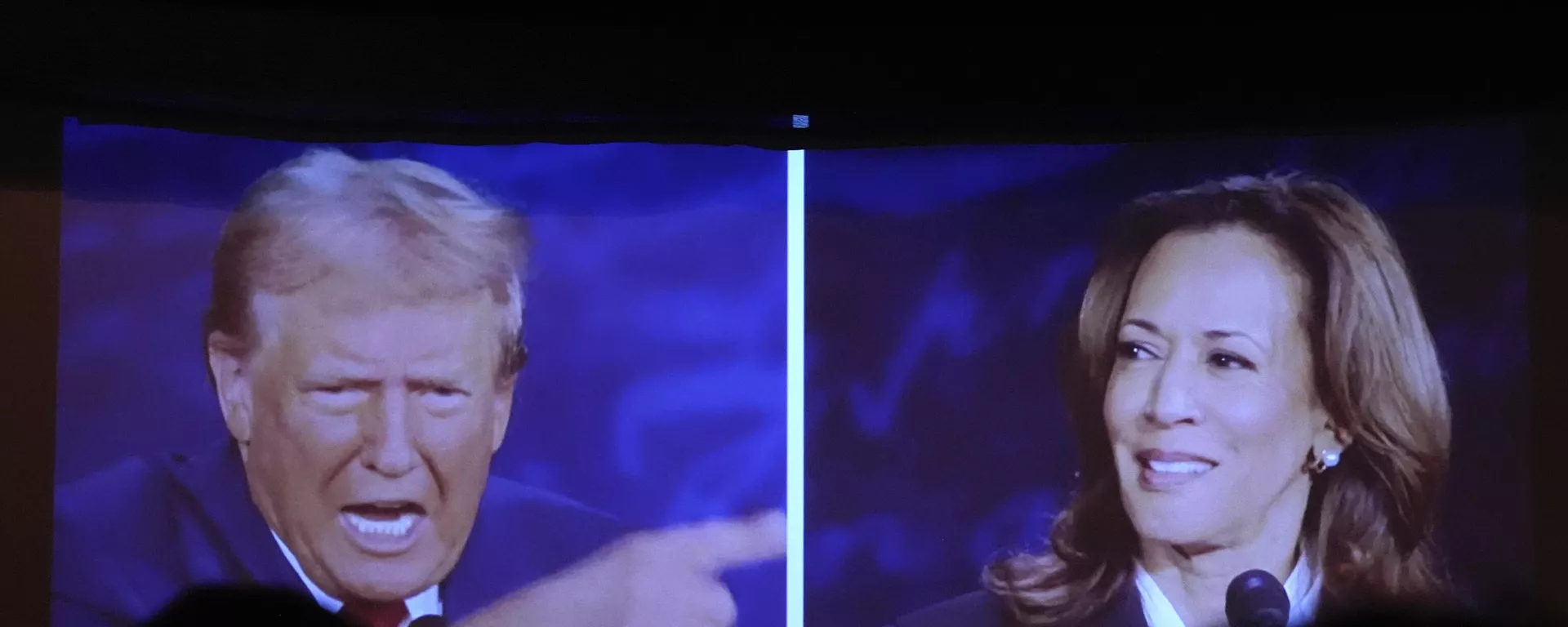 Republican presidential nominee former President Donald Trump, left, and Democratic presidential nominee Vice President Kamala Harris are seen on a screen during a presidential debate as people watch at One Longfellow Square, Tuesday, Sept. 10, 2024, in Portland, Maine.  - Sputnik International, 1920, 31.10.2024