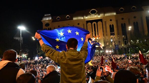 Protesters gather before the parliament building in Tbilisi, Georgia after parliamentary elections held over the weekend, which the opposition has contested. Monday, October 28, 2024. - Sputnik International