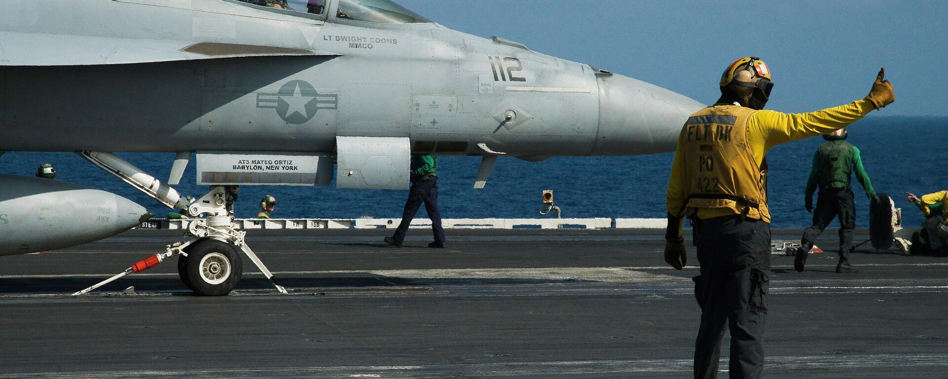 A crew member signals as a pilot prepares to launch an F/A-18 fighter jet on the deck of the USS Abraham Lincoln aircraft carrier in the Arabian Sea. 2019 file photo. The Lincoln is currently deployed in the Red Sea to assist in the US-led Operation Prosperity Guardian campaign against Yemen's Houthi militia - who have enforced a partial blockade of the Red Sea to Israeli-linked and allied merchant shipping. - Sputnik International, 1920, 31.10.2024