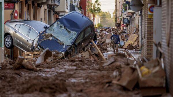 A man walks through a street affected by floods in Valencia, Spain, Saturday, Nov. 2, 2024. - Sputnik International