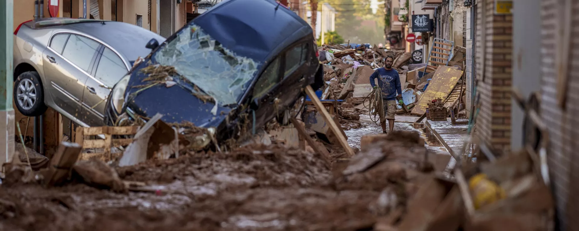 A man walks through a street affected by floods in Valencia, Spain, Saturday, Nov. 2, 2024. - Sputnik International, 1920, 02.11.2024