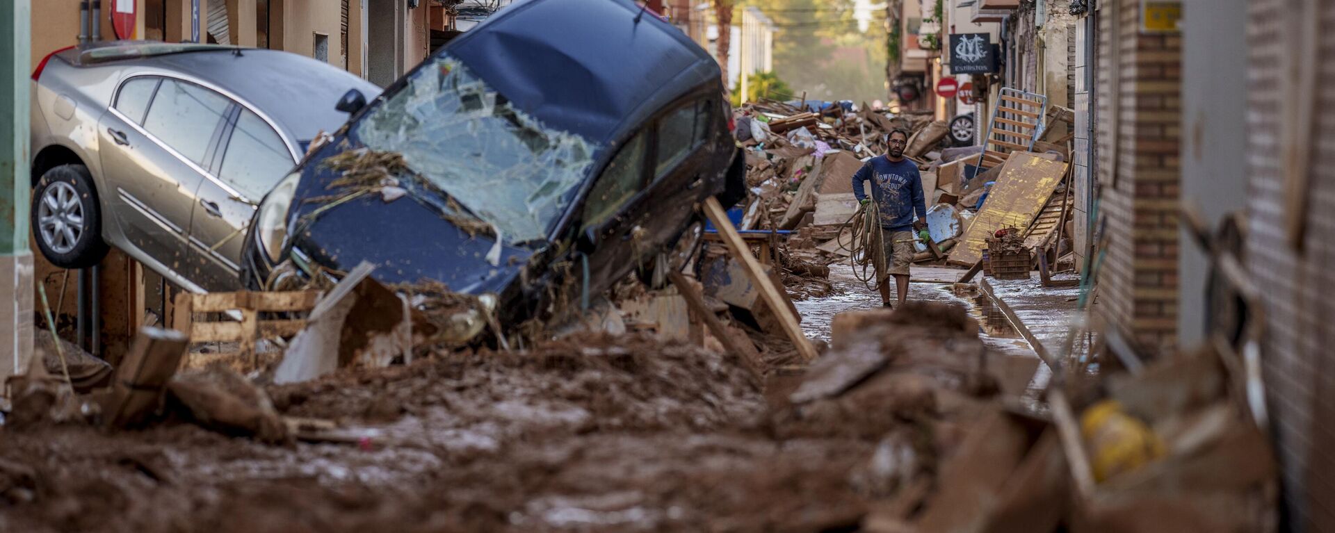 A man walks through a street affected by floods in Valencia, Spain, Saturday, Nov. 2, 2024. - Sputnik International, 1920, 02.11.2024