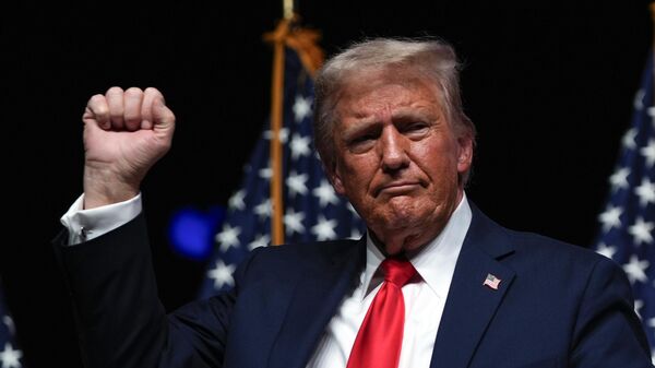 Republican presidential nominee former President Donald Trump gestures after a Tucker Carlson Live Tour show at Desert Diamond Arena, Thursday, Oct. 31, 2024, in Glendale, Ariz.  - Sputnik International