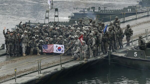 In this Dec. 10, 2015, file photo, US and South Korean army soldiers pose on a floating bridge on the Hantan river after a river crossing operation, part of an annual joint military exercise between South Korea and the US  in Yeoncheon, South Korea.  - Sputnik International