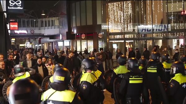 In this image taken from video, police stand guard forming a line near the Ajax stadium, in Amsterdam, the Netherlands, Thursday, Nov. 7, 2024. - Sputnik International