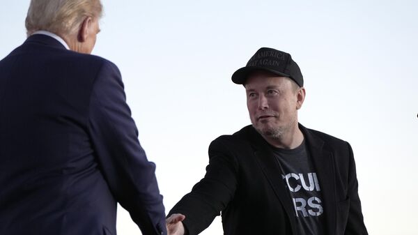 Donald Trump, left, shakes hands with Tesla and SpaceX CEO Elon Musk on Oct. 5, 2024. - Sputnik International