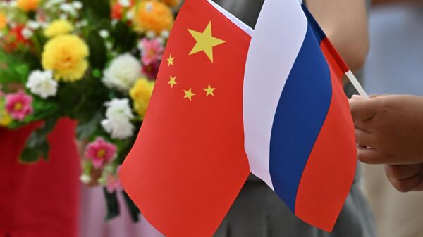 Russian and Chinese flags. File photo - Sputnik International