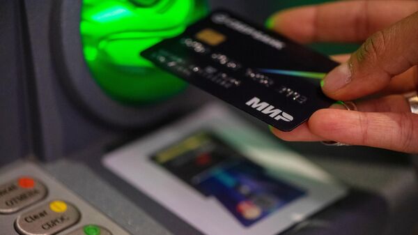 A MIR bank card is seen being used in Yerevan, Armenia. File photo - Sputnik International