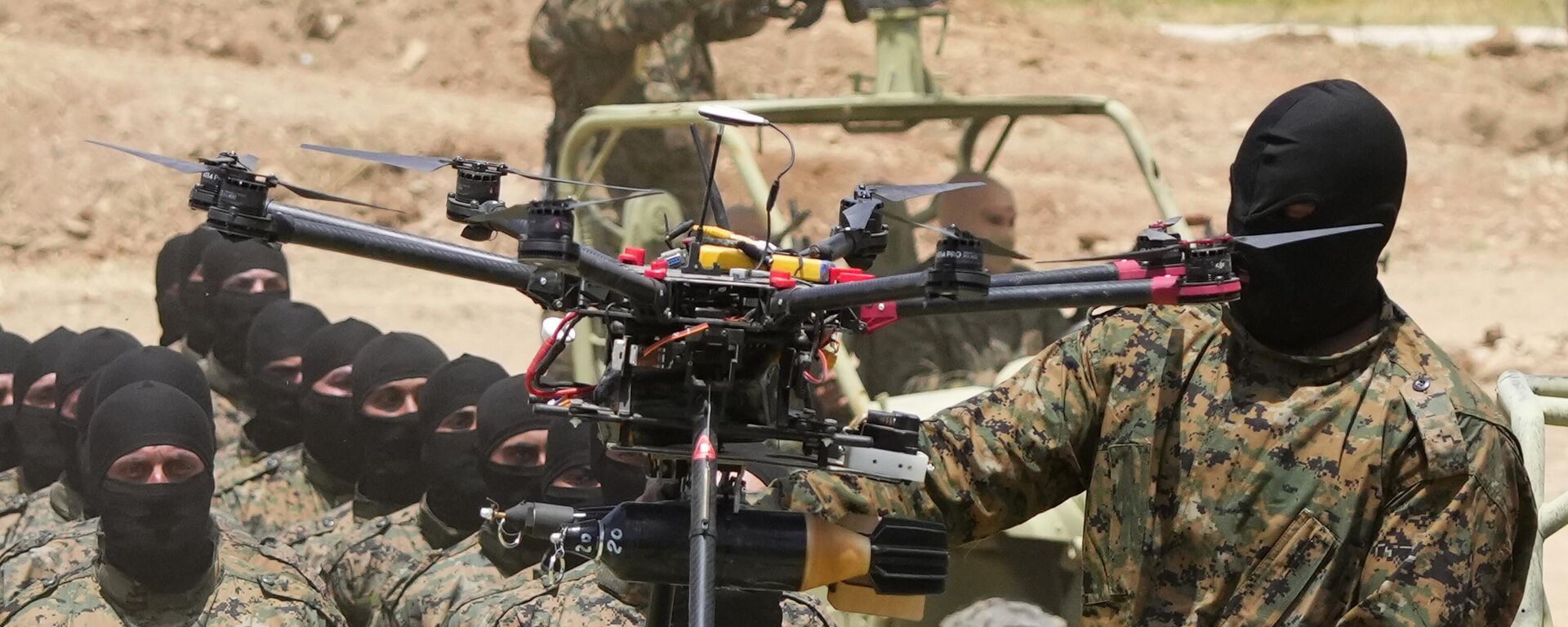 A Hezbollah fighter stands next to an armed drone during a training exercise in Aaramta village in the Jezzine District, southern Lebanon, on May 21, 2023 - Sputnik International, 1920, 19.04.2025