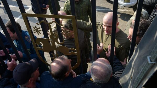 People gather outside the parliament to protest a Russia-related investment deal in Sukhum, Abkhazia. - Sputnik International