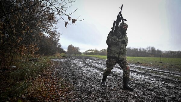 A service member of a sabotage and reconnaissance assault unit of the Russian army volunteer corps is seen in Kursk region - Sputnik International