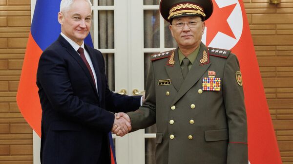 Russian Defence Minister Andrei Belousov and North Korean Defence Minister No Kwang Chol shake hands as they pose for photos before their meeting in Pyongyang, North Korea. - Sputnik International