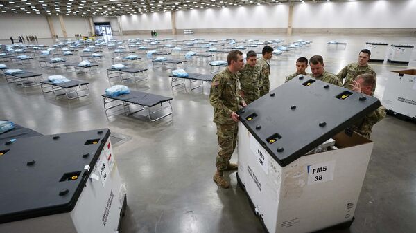 Texas Army National Guardsmen unpack crates of supplies as they set up a field hospital in response to the new coronavirus crisis at the Kay Bailey Hutchison Convention Center on Tuesday, March 31, 2020, in Dallas - Sputnik International