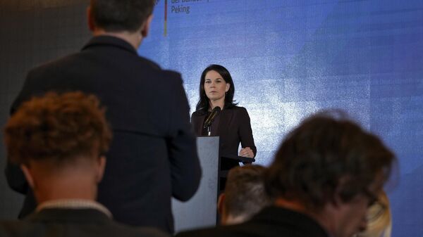 German Foreign Minister Annalena Baerbock listens to a question from a journalist during a press briefing at a hotel in Beijing, Monday, Dec. 2, 2024.  - Sputnik International