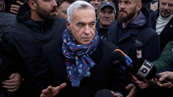 Calin Georgescu, an independent candidate for president who won the first round of presidential elections, speaks to media outside a voting station demanding to be allowed to vote after Romania's Constitutional Court annulled the first round of presidential elections, in Mogosoaia, Romania. - Sputnik International