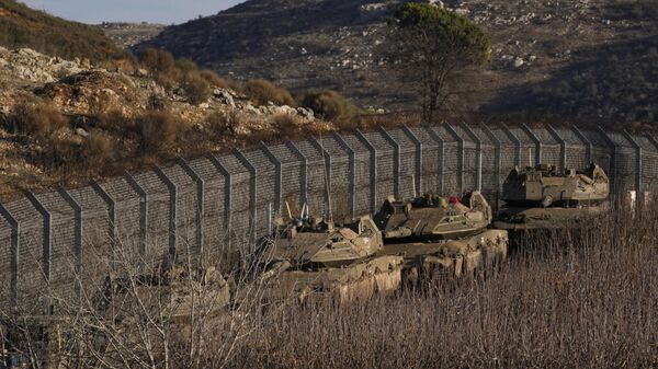 Israeli armored vehicles park along the so-called Alpha Line that separates the Israeli-annexed Golan Heights from Syria, Sunday, Dec. 8, 2024.  - Sputnik International