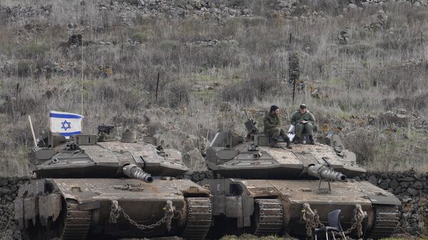 Israeli soldiers sit atop an armoured vehicle near the so-called Alpha Line that separates the Israeli-occupied Golan Heights from Syria Saturday Dec. 7, 2024.  - Sputnik International