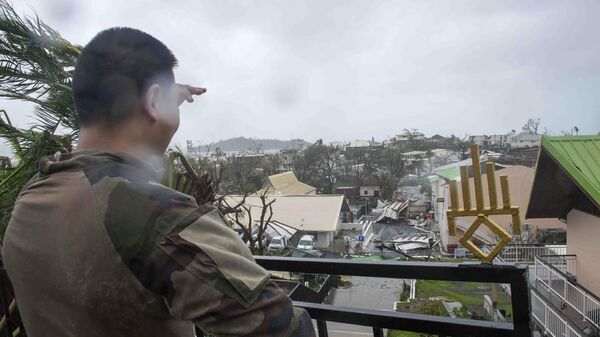 This photo provided by the French Army shows a soldier looking at damages in the French territory of Mayotte in the Indian Ocean, after Cyclone Chido caused extensive damage with reports of several fatalities.  - Sputnik International