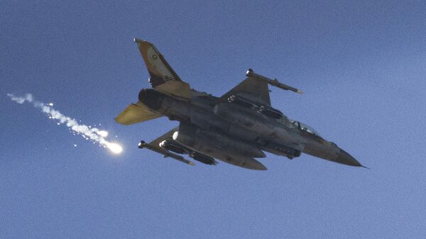 An Israeli fighter jet releases flares as it flies over the Gaza Strip, as seen from southern Israel, Dec. 9, 2023.  - Sputnik International