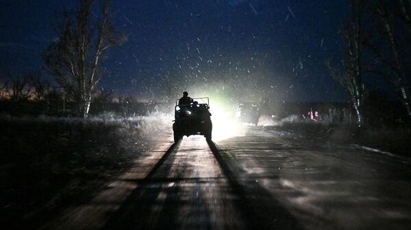 Russian servicemen ride a vehicle along a road  - Sputnik International