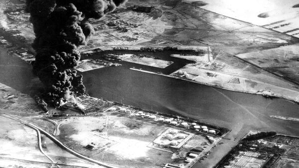 In this Nov. 11, 1956 file photo, fuel installations on the Suez Canal burn after an attack by aircraft of the Sea Venom Squadron from HMS Eagle as Britain, France and Israel intervened militarily and occupied the canal zone following Egypt nationalizing the canal.  - Sputnik International