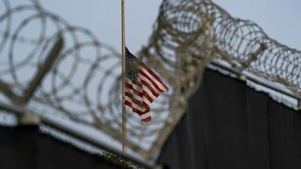 US flag flies at half-staff as seen from Camp Justice in Guantanamo Bay Naval Base, Cuba, Aug. 29, 2021. - Sputnik International