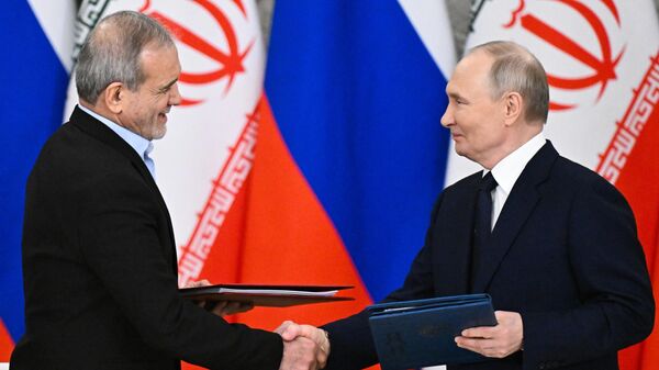 Presidents Putin and Pezeshkian exchange signed copies of the new Russia-Iran Comprehensive Strategic Partnership Agreement in the Moscow Kremin. January 17, 2025. - Sputnik International