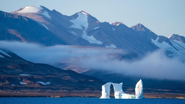 An iceberg floats in the Scoresby Sund, on Sept. 12, 2023, in Greenland.  - Sputnik International