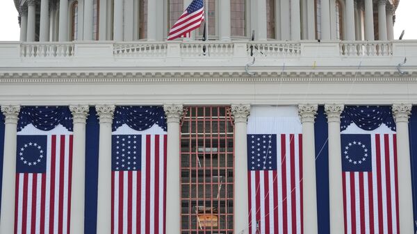 FILE - Flags hang in place on the West Front of the U.S. Capitol ahead of President-elect Donald Trump's upcoming inauguration, in Washington, Jan. 12, 2025. - Sputnik International