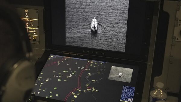 Crew members aboard a French Navy Atlantique 2 surveillance plane patrolling Thursday, Jan. 23, 2025, over the Baltic Sea as part of the NATO military alliance's Baltic Sentry mission to protect undersea cables and pipelines from sabotage watch one of the onboard monitors showing images from the aircraft's cameras of a ship navigating on the Baltic.  - Sputnik International