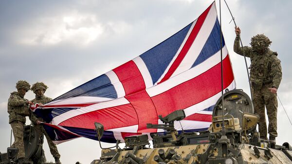 British servicemen unfurl the Union Jack flag before the start of the Steadfast Dart 2025 exercise at a training range in Smardan, eastern Romania, Wednesday, Feb. 19, 2025. - Sputnik International