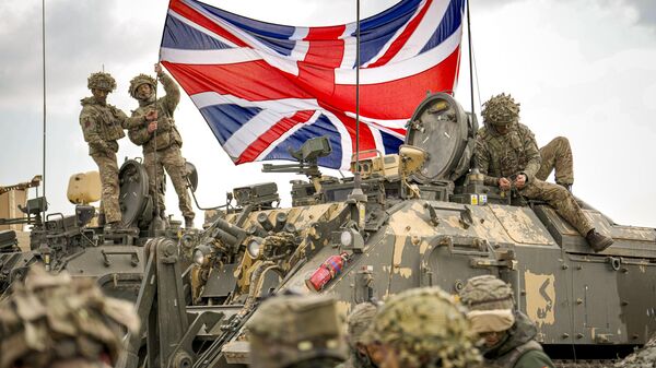 British servicemen unfurl the Union Jack flag before the start of the Steadfast Dart 2025 exercise, involving some 10,000 troops in three different countries from nine nations and represent the largest NATO operation planned this year, at a training range in Smardan, eastern Romania, Wednesday, Feb. 19, 2025. - Sputnik International