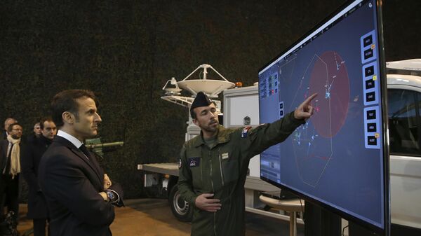 French President Emmanuel Macron, left, listens to explanations as he visits the Mont-de-Marsan air base. File photo. - Sputnik International