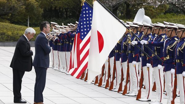 Japan's Defense Minister Gen Nakatani, left, and US Defense Secretary Pete Hegseth review an honor guard during a welcome ceremony at the Ministry of Defense in Tokyo Sunday, March 30, 2025. - Sputnik International