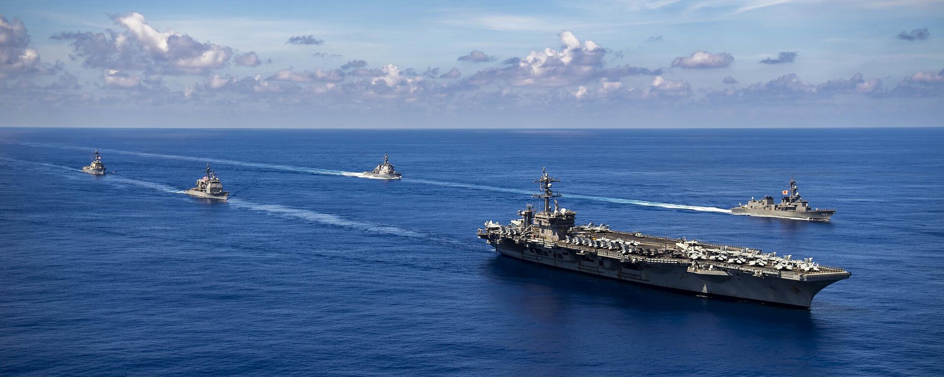 USS Carl Vinson and missile destroyer escorts sail with Japanese warships. File photo. - Sputnik International, 1920, 02.04.2025