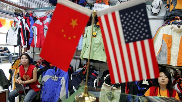Chinese vendors at a clothing stall wait near Chinese and US flags for customers in Beijing, China, Tuesday, Sept 6, 2005.  - Sputnik International