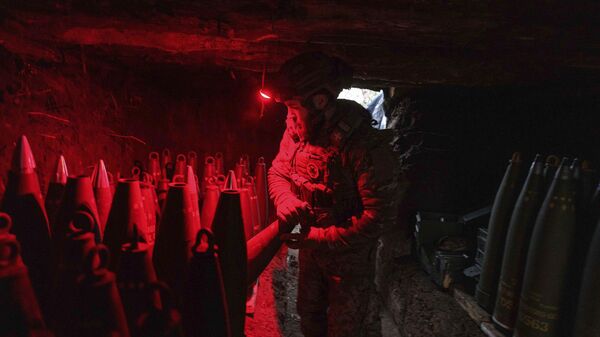 A Ukrainian serviceman of the 148th artillery brigade prepares 155mm artillery shells for a M777 howitzer before firing towards Russian positions in Donetsk region, Jan. 26, 2025. - Sputnik International