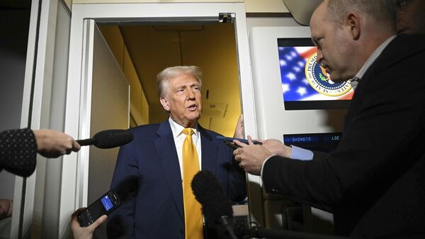 President Donald Trump speaks to the reporters on board Air Force One on the way to Miami, Saturday, April 12, 2025 - Sputnik International