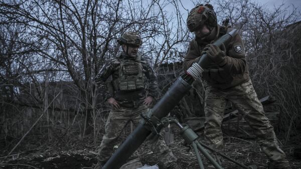 In this photo taken on March 16, 2025 and provided by Ukraine's 24th Mechanized Brigade press service, Ukrainian soldiers fire 120mm mortar towards Russian army positions near Chasiv Yar, Donetsk region, Ukraine, Sunday, March 16, 2025. - Sputnik International