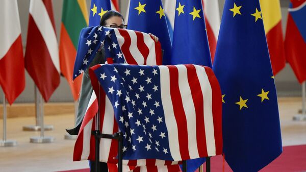 A member of protocol adjusts the U.S. and EU flags prior to the arrival of US Secretary of State Antony Blinken and European Council President Charles Michel during an extraordinary EU foreign ministers meeting at the European Council building in Brussels, Friday, March 4, 2022 - Sputnik International