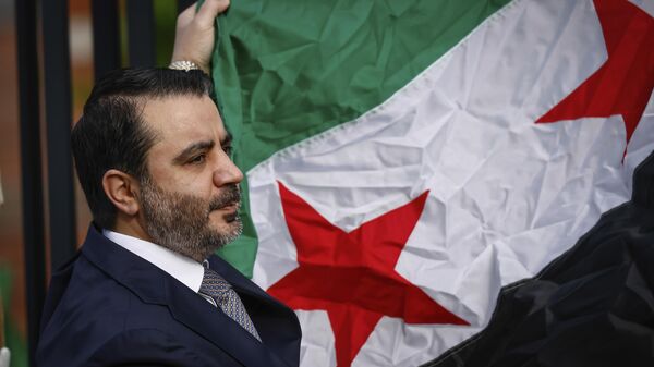 Syria's Foreign Minister Asaad Al-Shibani holds the Syrian Flag during a ceremony where the Syrian flag was added to the 100 flags flying in line at United Nations Headquarters on Friday, April 25, 2025.  - Sputnik International