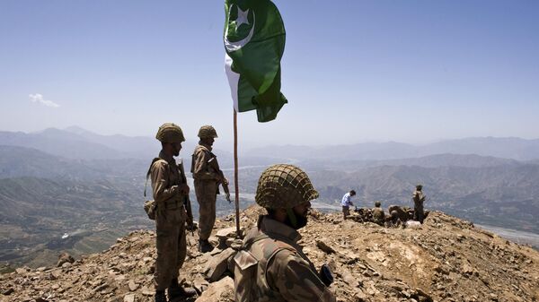 A Pakistani flag flies over government troops installed on top of a defense position on a former base of Taliban militants overlooking the Swat Valley, at Banai Baba Ziarat area, northwest of Pakistan's capital Islamabad, Pakistan, Friday, May 22, 2009 - Sputnik International