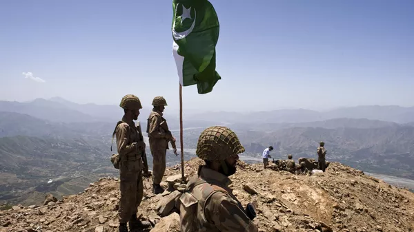 A Pakistani flag flies over government troops installed on top of a defense position on a former base of Taliban militants overlooking the Swat Valley, at Banai Baba Ziarat area, northwest of Pakistan's capital Islamabad, Pakistan, Friday, May 22, 2009 - Sputnik International