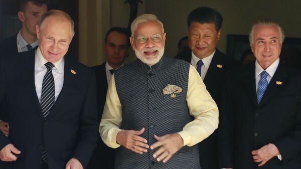 Leaders of BRICS countries, from left, Russian President Vladimir Putin, Indian Prime Minister Narendra Modi, Chinese President Xi Jinping, and former Brazilian President Michel Temer, arrive for a group photo for media at the start of the summit in Goa, India, Sunday, Oct. 16, 2016 - Sputnik International