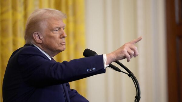 President Donald Trump points to a reporter as he answers questions during a news conference on Feb. 13, 2025, in Washington. - Sputnik International