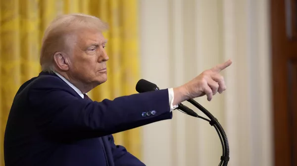 President Donald Trump points to a reporter as he answers questions during a news conference on Feb. 13, 2025, in Washington. - Sputnik International