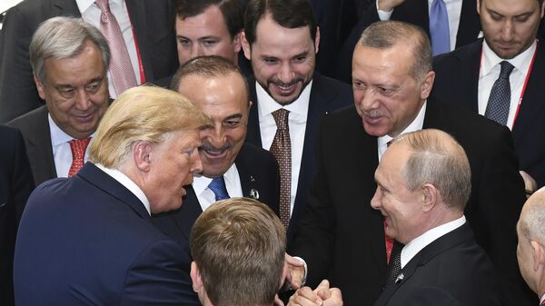 US President Donald Trump, left, shakes hands with Russian President Vladimir Putin, right, as Turkiye's President Recep Tayyip Erdogan, 2nd right and United Nations Secretary-General Antonio Guterres, left, look on, on the sidelines of the G-20 summit in Osaka, Japan, Saturday, June 29, 2019 - Sputnik International
